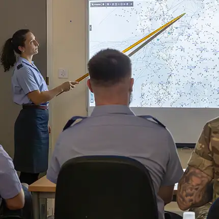 RAF Inteligence Officer briefing RAF personnel using projected map