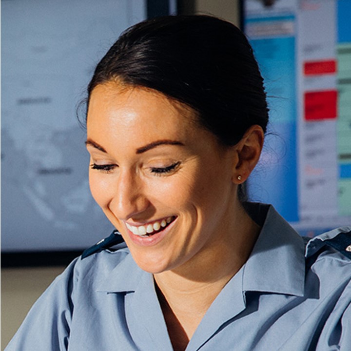 Female RAF Apprentice in uniform, in training room, smiling