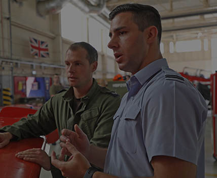RAF Engineering Officer (Aero Systems) briefing technician in Red Arrows hanger beside Hawk aircraft