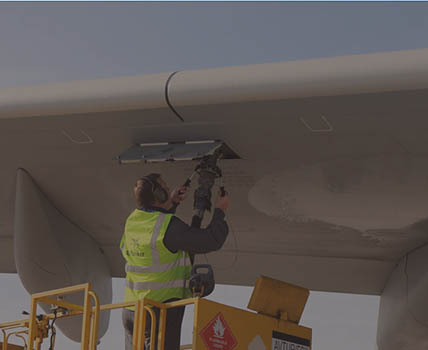 RAF Supplier attaching fuel hose to aircraft wing
