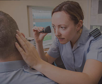 RAF Medical Officer examining ear of RAF patient