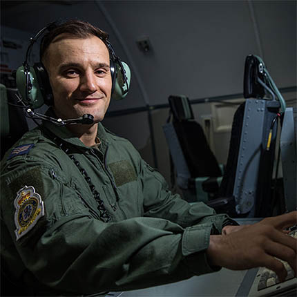 RAF Air Traffic and Weapons Controller wearing headset operating control equipment