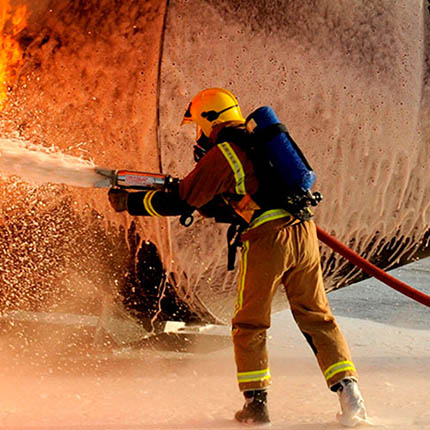 RAF Firefighter extinguishing practice fire with foam