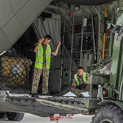 RAF Movers working with telehandler to load cargo to aircraft's rear ramp