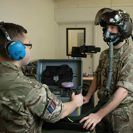 RAF Survival Equipment Specialists testing pilot's flight helmet 
