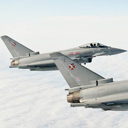 pair of RAF Typhoon jets flying above clouds