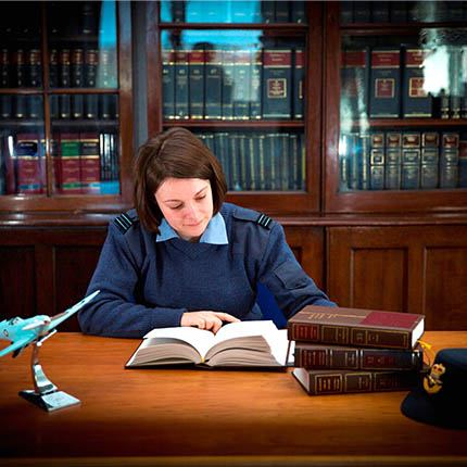 RAF Legal Officer reading book at desk