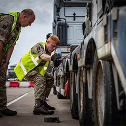 RAF Driver securing Land Rover to Low loader trailer