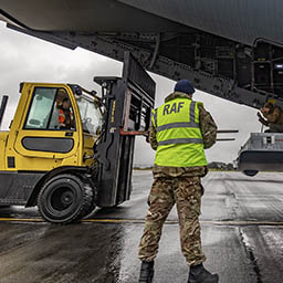 RAF Mover supervising forklift driver loading cargo onto aircraft rear ramp
