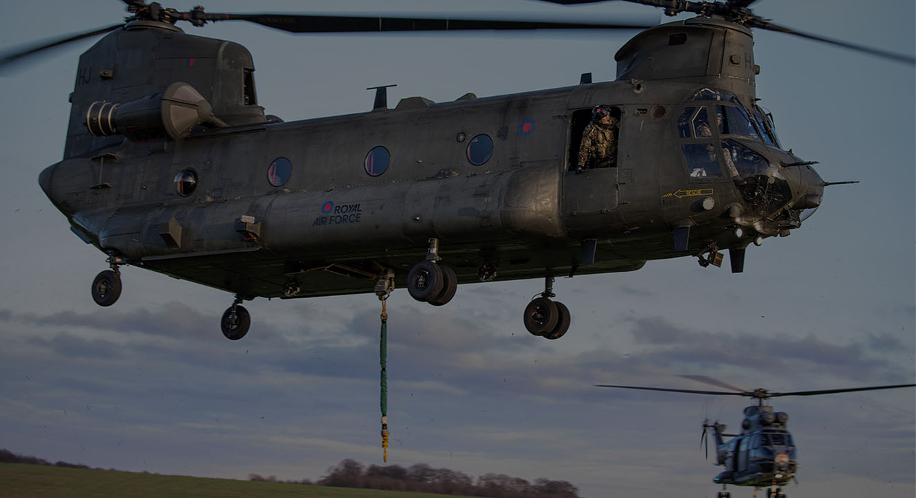 RAF Chinook and Puma helicopters hovering after depositing underslung loads