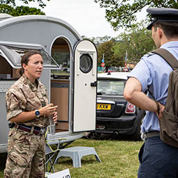 RAF Chaplain offering Pop-up Padre service from caravan at RAF Benson, talking to junior officers.