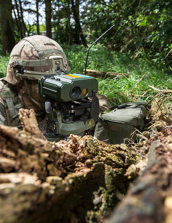 RAF Regiment Gunner in undergrowth using laser range-finder