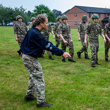 RAF Physical Training Instructor leads a Battle PT session to a course of Avionic Technicians.