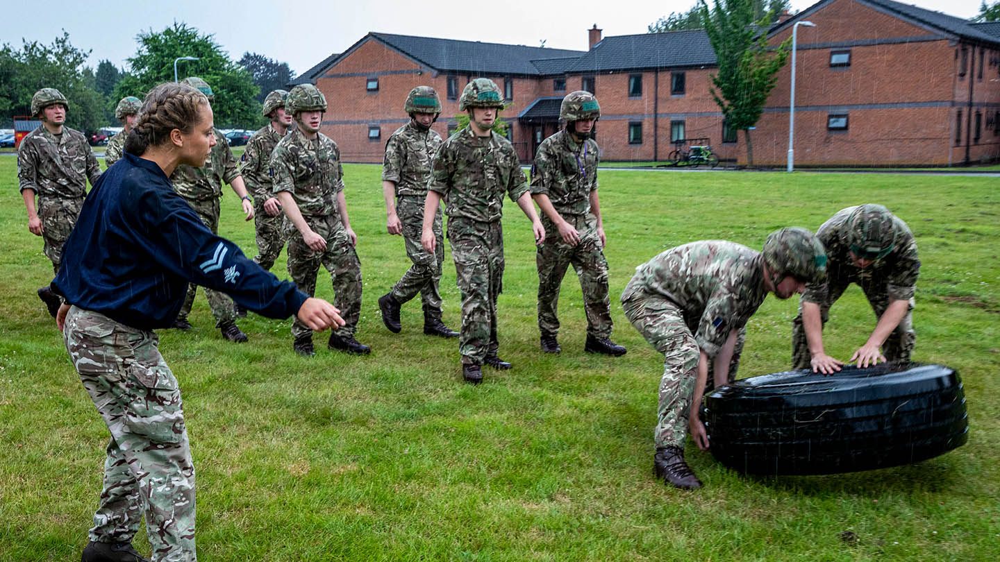 RAF Physical Training Instructor leads a Battle PT session to a course of Avionic Technicians.