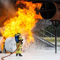 RAF Firefighters spraying foam on a burning practice aircraft rig