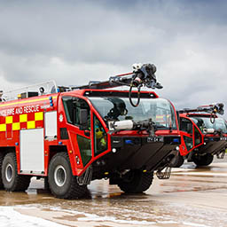 RAF Firefighters preparing to spray foam on burning practice aircraft rig