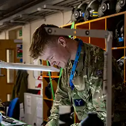 RAF Aircraft Technician - Survival Equipment testing flight helmet on workbench