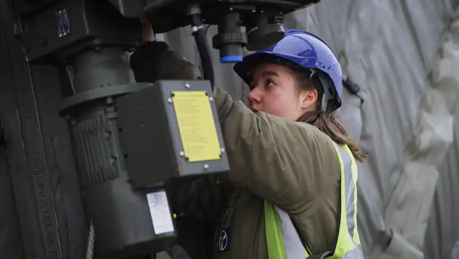 RAF Vehicle and Mechanical Equipment Technician working on portable aircraft hanger drive gear
