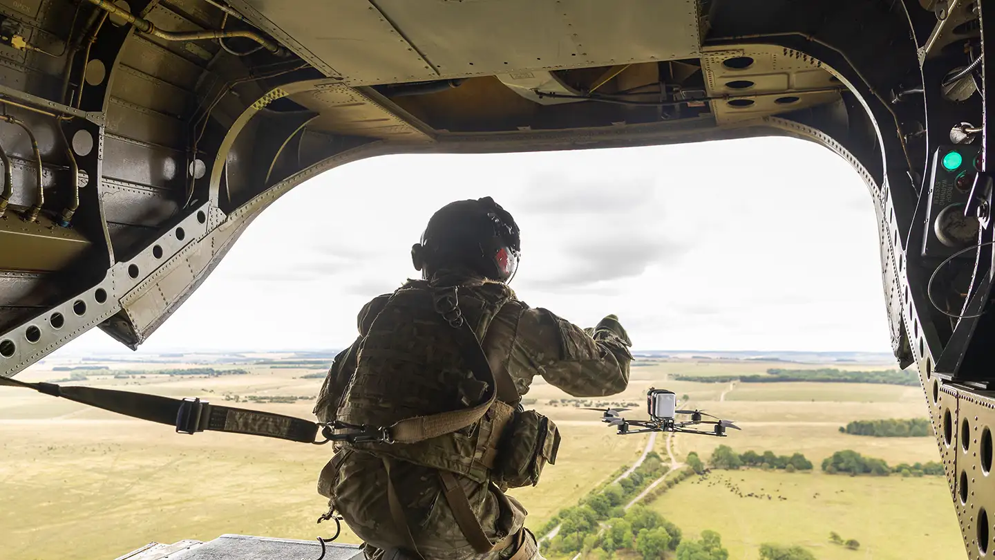 RAF Weapon Systems Operator launching UAV from Chinook helicopter ramp while airborne
