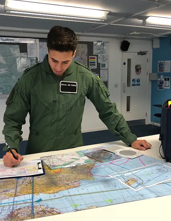 RAF Weapon Systems Officer (WSO) reviewing flight charts to plan mission