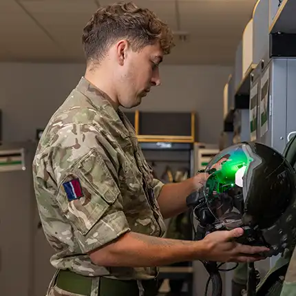 RAF Air Technician Survival Equipment inspecting pilot's helmet