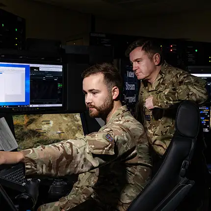 RAF Cyberspace Communications Specialist operating equipment with RAF Engineer Officer (Communications Electronics)