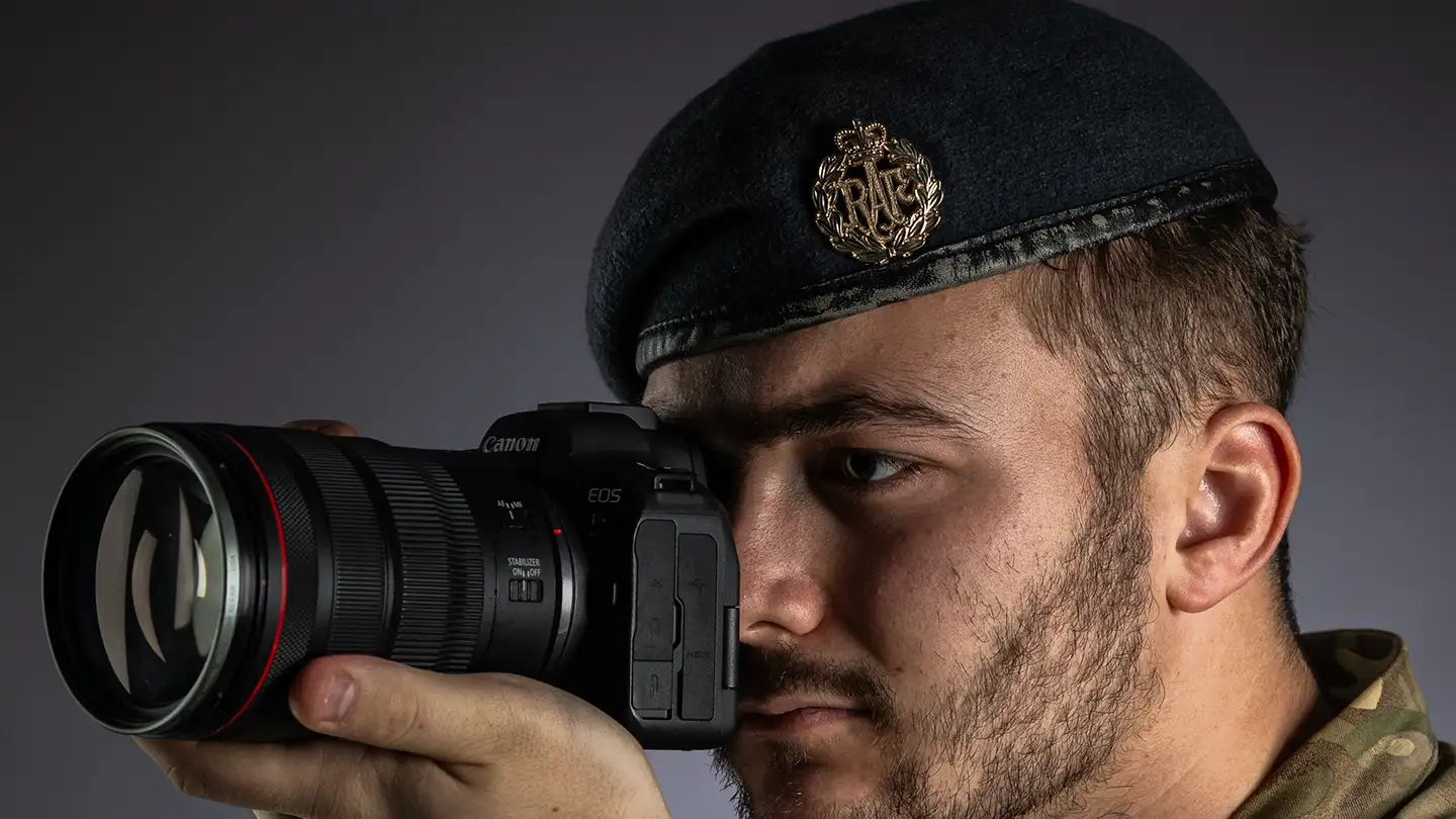 RAF Photographer looking through lens of digital camera in studio
