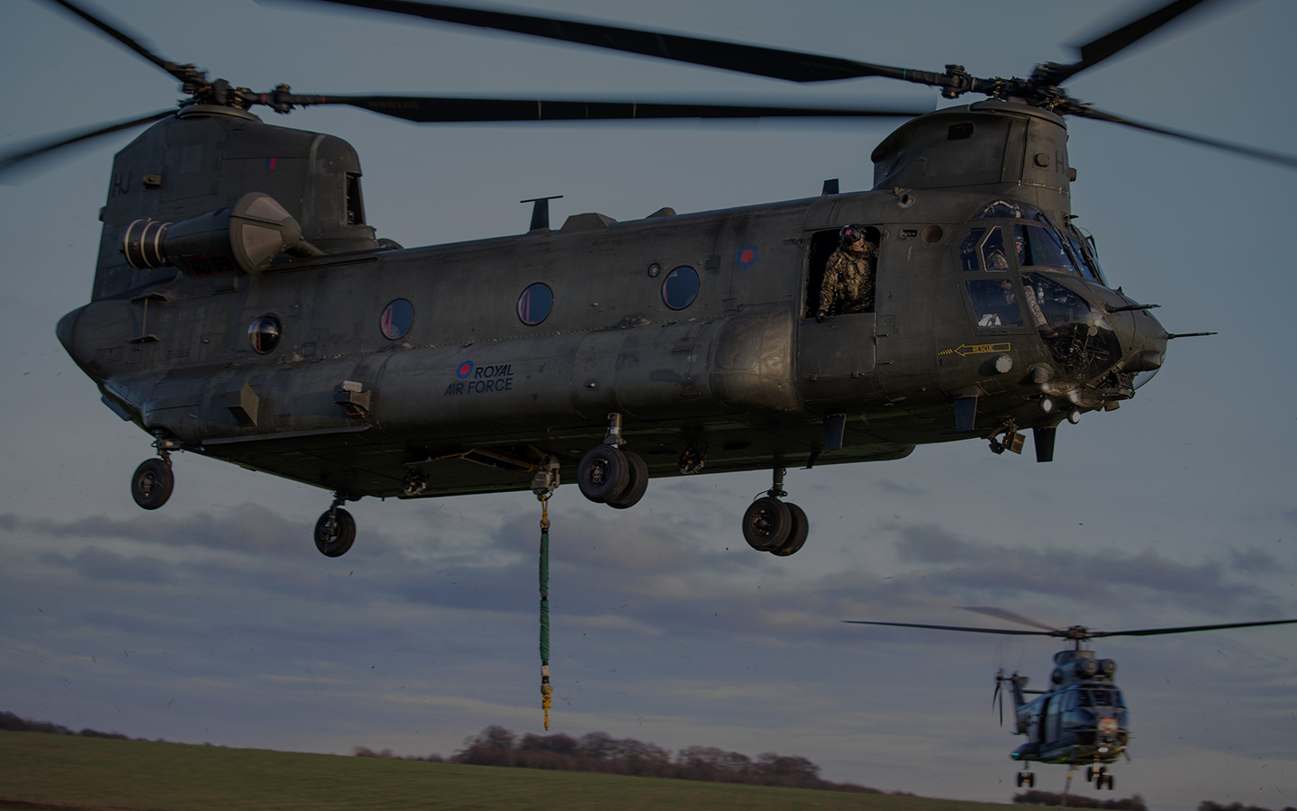 RAF Chinook and Puma helicopters hovering after depositing underslung loads